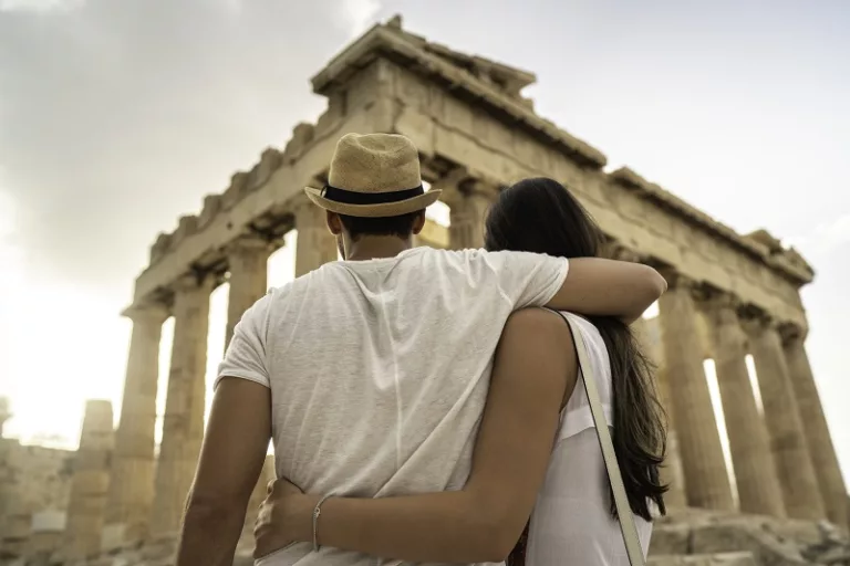 Rear View Of A Young Couple Embracing Standing In The Acropolis, Athens