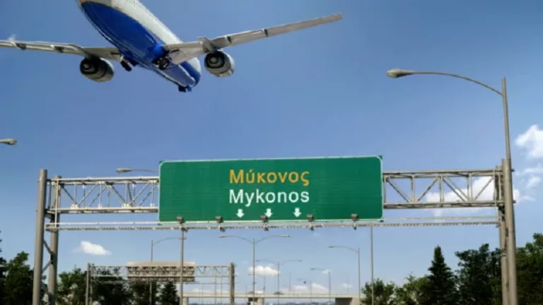 Airplane flying over airport signboard